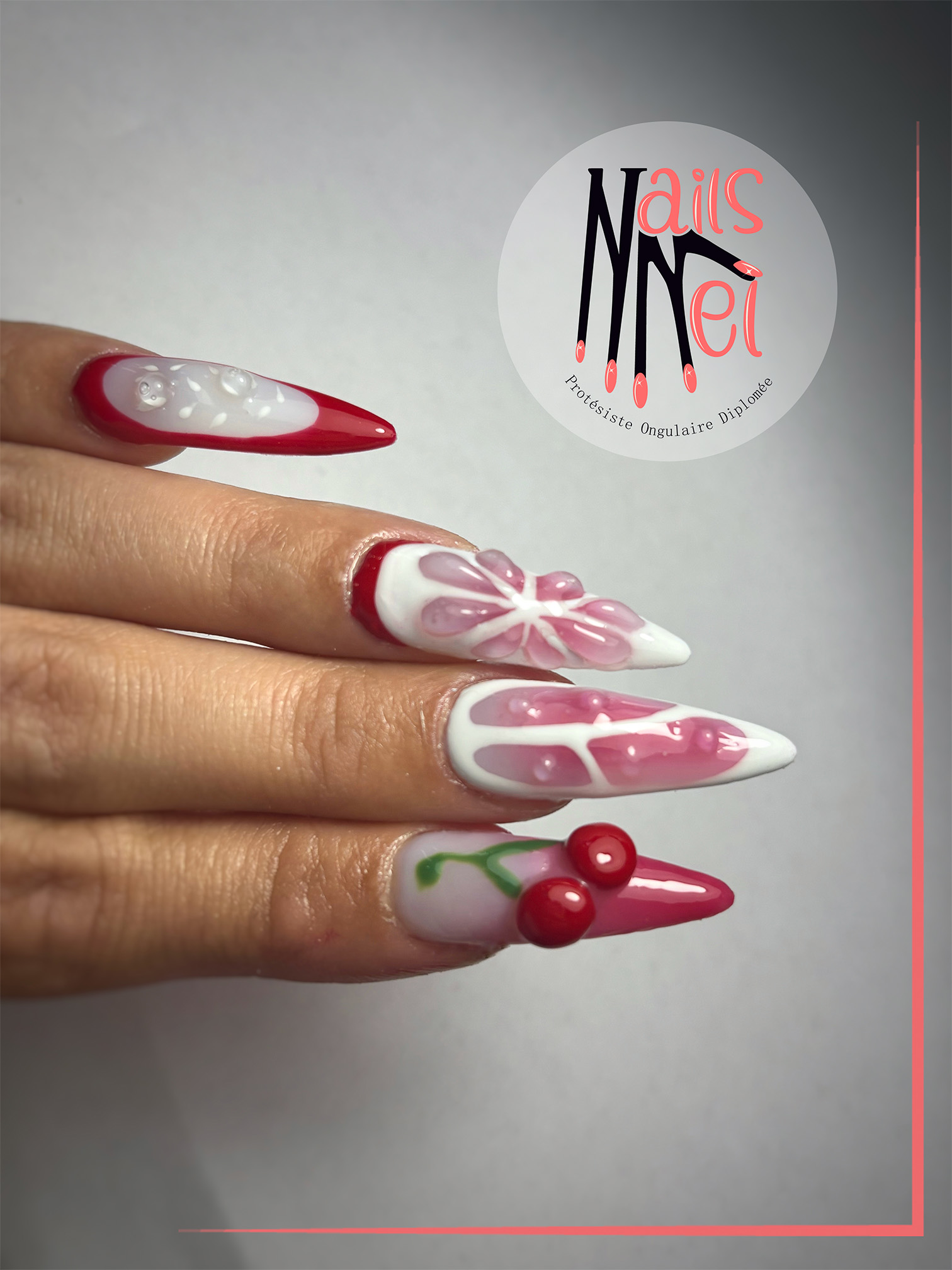 pose américaine réalisée à Hénin-Beaumont par Mélanie, prothésiste ongulaire, rouge cerise et blanc avec cerise en relief 3d